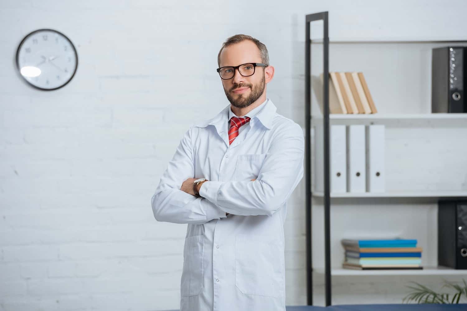 portrait-of-male-chiropractor-in-white-coat-and-ey-2022-11-02-02-22-21-utc-min-min.jpg
